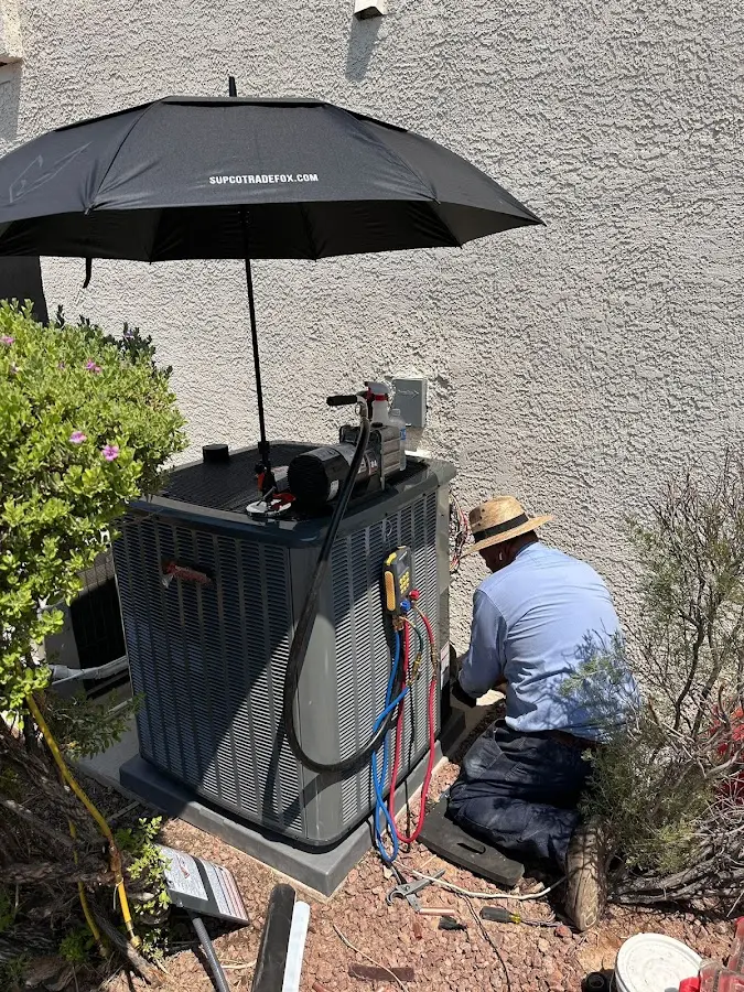 HVAC technician performing outdoor AC maintenance in Wildewood
